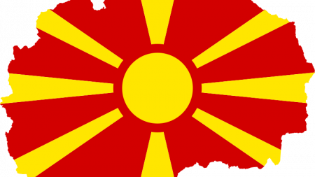 Flag of Macedonia with yellow sun and red background in shape of Macedonia