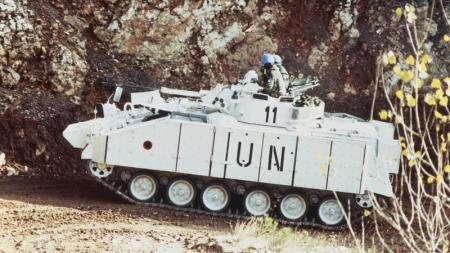 White UN tank in wooded area