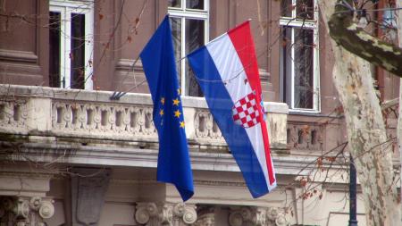Croatian and EU flags hanging on a building