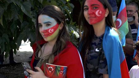Image of two women with facepaint of Azerbaijan and Turkish flags