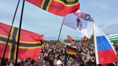 Rally of people with Wirmer flag of Germany and Pegida flag