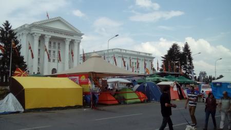 Image of tents in front of large white building