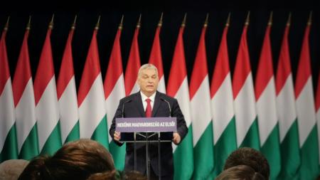 Viktor Orban in front of several Hungarian flags